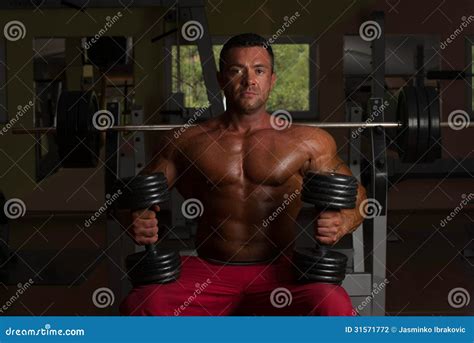 Shirtless Bodybuilder Posing With Dumbbell At The Bench Stock Photo Image Of Exercise Flex