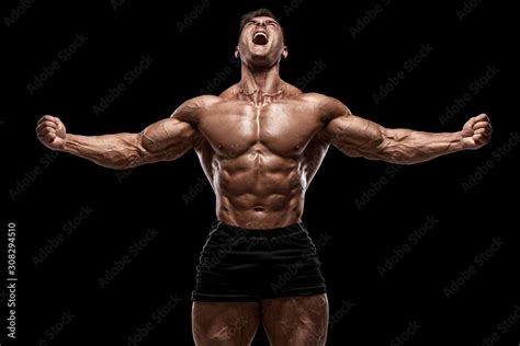 Muscular Man Showing Muscles Isolated On The Black Background Strong