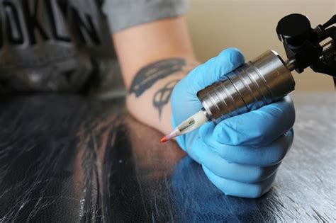 Premium Photo Tattoo Artist At Work Close Up