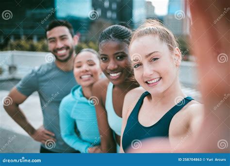 Portrait Of A Diverse Group Of Happy Sporty People Taking Selfies While Exercising Together