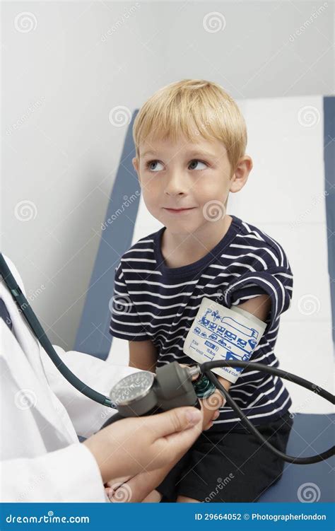 Doctor Checking Boy S Blood Pressure Stock Photo Image Of Care