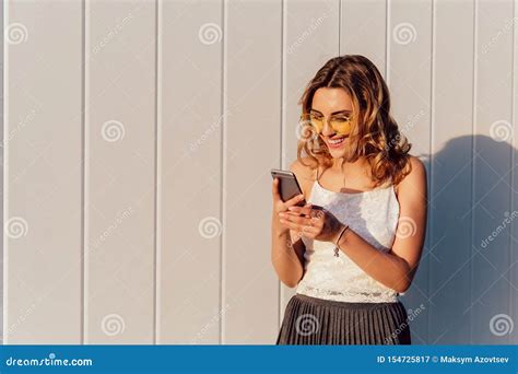 Cheerful Girl Using A Smartphone Outdoors Stock Image Image Of Smartphone Cute 154725817