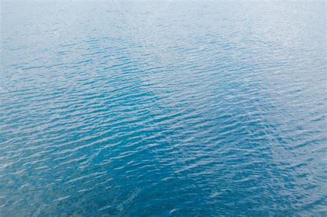 Premium Photo Abstraction Of The Surface Of Blue Water Reflected By