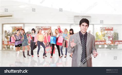 Portrait Of A Salesman In The Shopping Mall With His Customers On