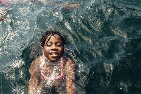 black girl swimming in a lake by stocksy contributor gabi bucataru stocksy