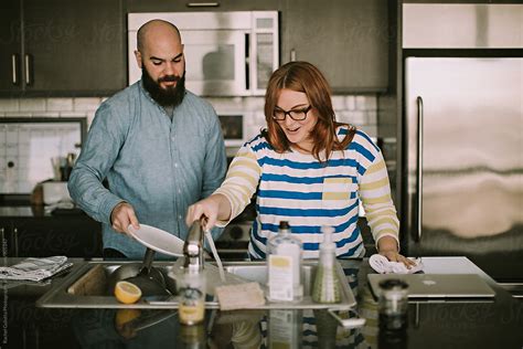 A Babe Couple Does Dishes Together In Their Kitchen By Stocksy Contributor Mango Street Lab