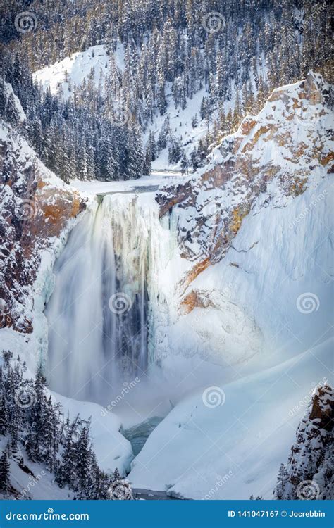 Big Canyon Waterfall Partially Frozen And Surrounded By Snow In