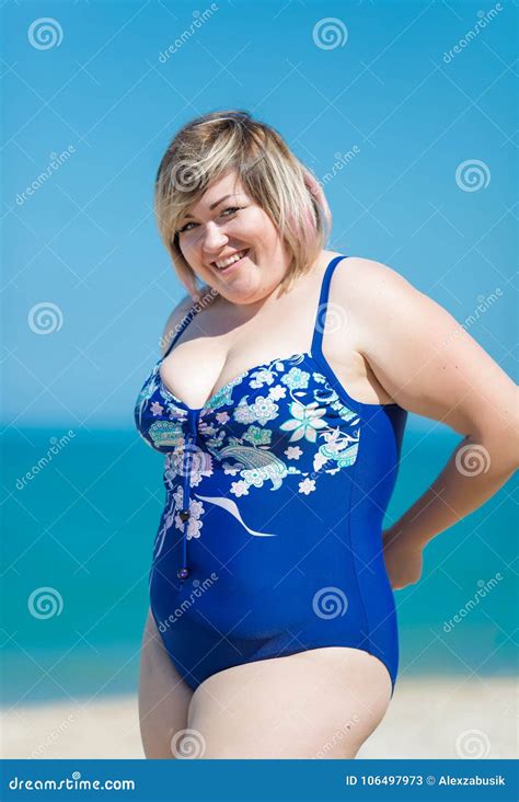 Overweight Woman Adjusting Her Blue One Piece Swimsuit Smiling Stock Image Image Of Heavy