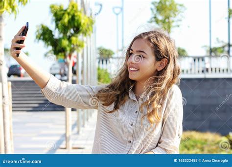 Beautiful Teenager Girl Taking A Selfie On The Promenade On A Sunny Day