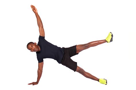 Fit Man Doing Side Plank With Arm And Leg Raised