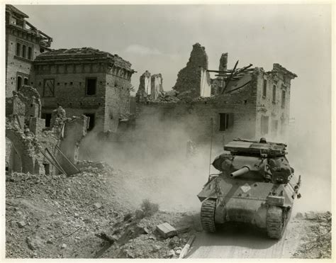 M10 Tank Destroyer Rolls By Destroyed Buildings In Italy Circa 1944