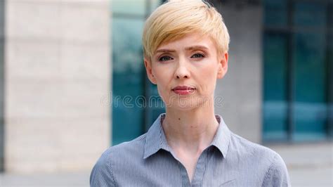 close up female serious face portrait outdoors caucasian middle aged business woman boss blonde
