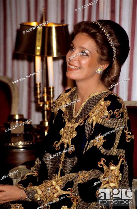 Portrait Of A Shining Queen Noor Of Jordan Seated On An Armchair During A Diplomatic Meeting