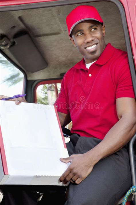 Young African American Male Standing With Packages Near Delivery Truck