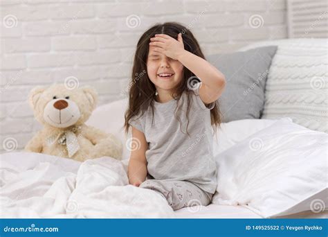 Cute Little Child Girl Wakes Up From Sleep In Bed Stock Photo Image
