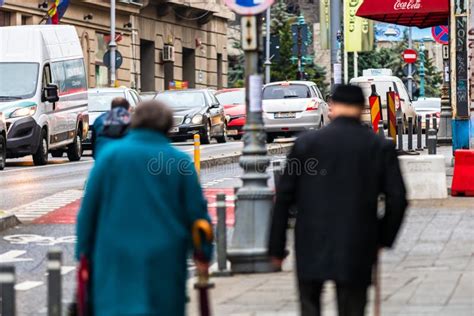 People Walking Or Crossing The Street In Downtown Bucharest Romania