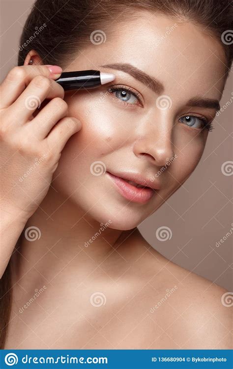 Beautiful Young Girl With Natural Nude Make Up And Highlighter Pencil