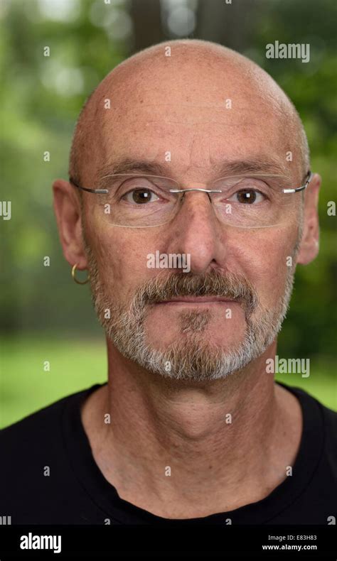 Face Of Retired Bald Man About 60 Years Old With Beard And Glasses In