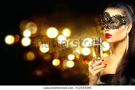 Sexy Model Woman With Glass Of Champagne Wearing Venetian Masquerade Mask At Party Drinking