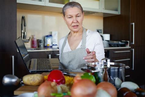 Mature Woman In Kitchen Preparing Food Stock Image Image Of Health
