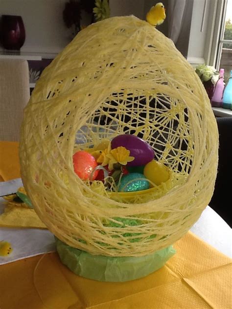 Large Egg Shaped Decoration Made With A Balloon And Yellow Wool Egg