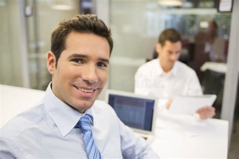 Portrait Of Smiling Businessman Working In Office Looking Camera Stock