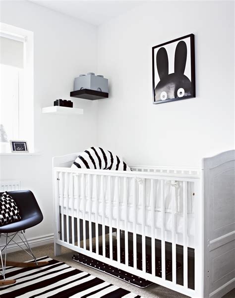 Black walls and white furnishings make a bold statement in this modern nursery. Exploring the Elegance and Minimalism of Monochrome Nurseries