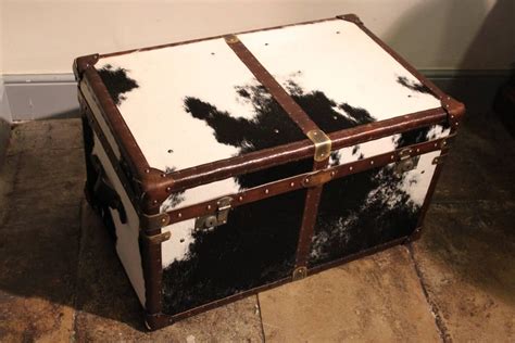 Features three drawers with aluminium facing for a sleek look which also provides plenty of storage. Bespoke Cowhide Trunk / Coffee Table at 1stdibs