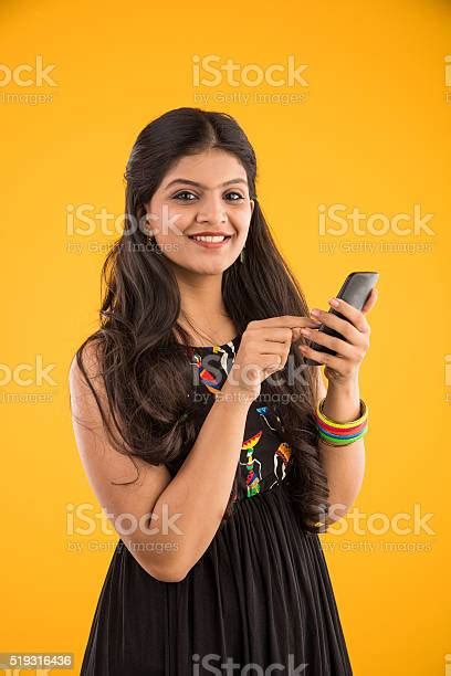 Smart Indian Girl Using Smartphone Isolated Over Yellow Background