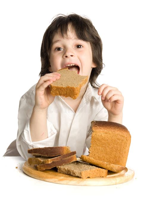 The Little Boy Which Eating A Bread On Desk Stock Image Image Of