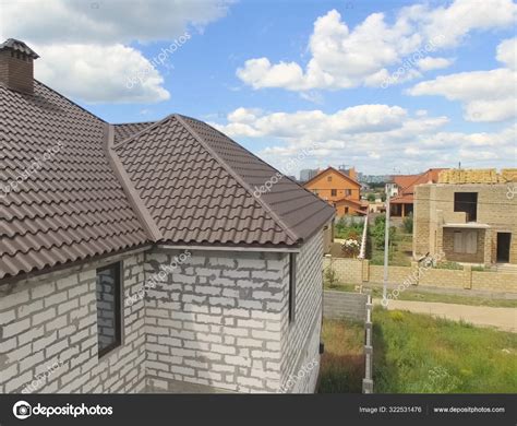 Interlock metal roofing systems is your best choice! Corrugated metal roof and metal roofing. Modern roof made of met — Stock Photo © Ludya #322531476