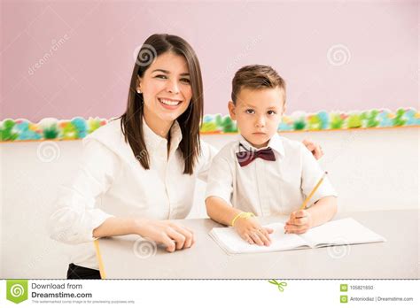 Patient Teacher Helping A Student In Class Stock Photo Image Of Group