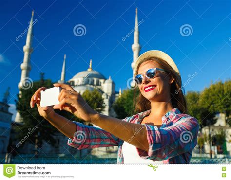 Girl Making Selfie By The Smartphone On The Background Of The Bl Stock