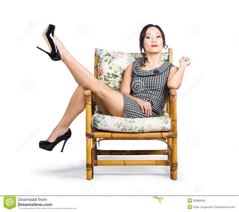Young Vintage Fashion Model Sitting On Chair Royalty Free