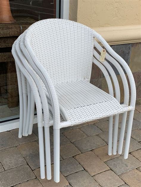 Four white, all-weather wicker patio chairs by Ebel. High quality