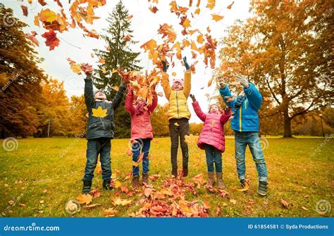 Happy Children Playing With Autumn Leaves In Park Stock Image Image