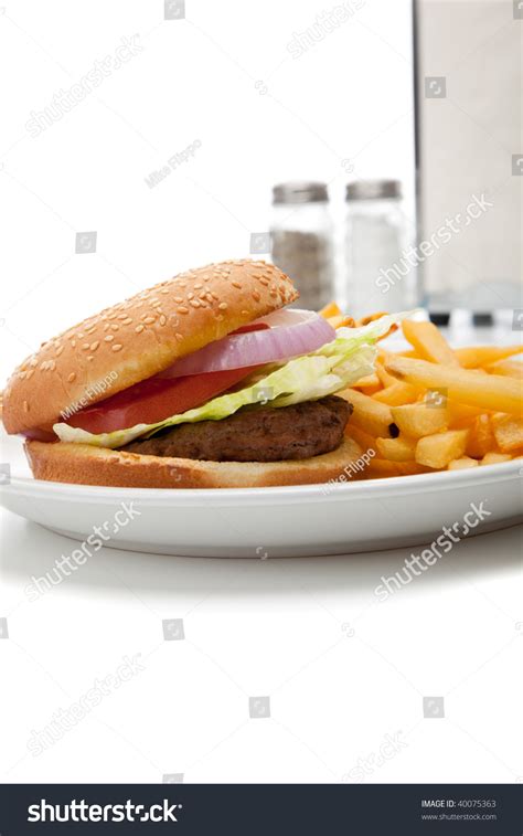 A Hamburger And French Fries Diner Set Up With Salt And Pepper Shaker