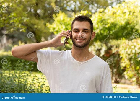 Man With Beard Talking On Mobile Phone Outdoors Stock Photo Image Of
