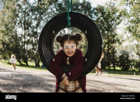 Young Girl Playing On Tire Swing Stock Photo Alamy