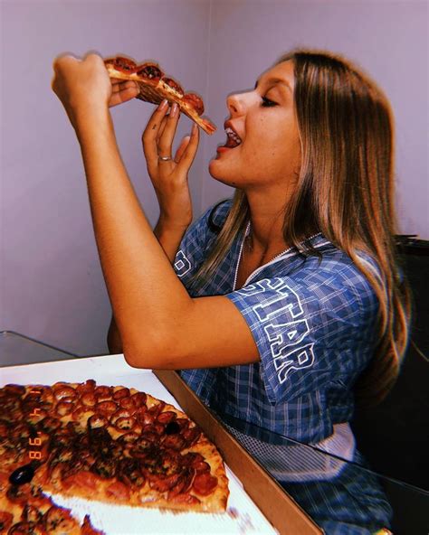 A Woman Eating A Slice Of Pizza From A Box