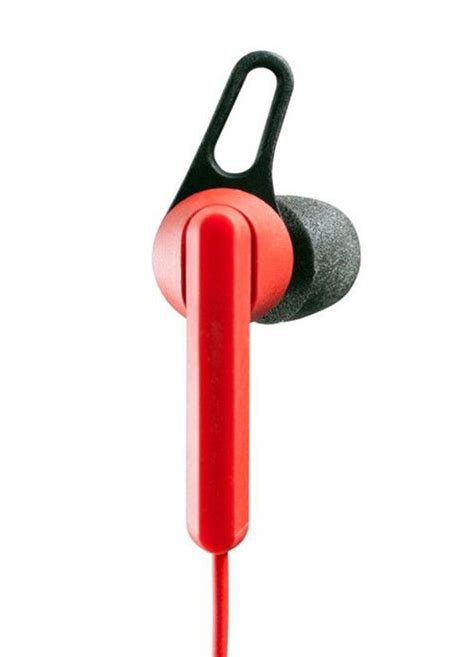 A Pair Of Red Ear Buds Sitting Next To Each Other