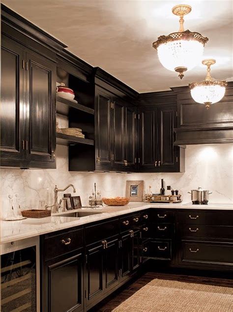 More + product details close. Black kitchen cabinetry with gold hardware. White marble ...