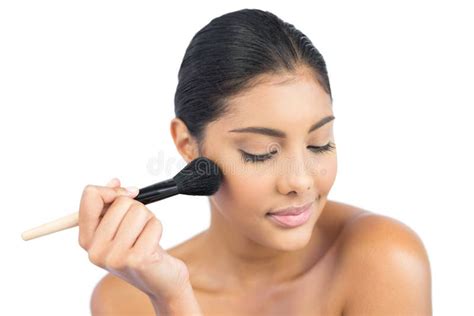 Content Nude Brunette Using Powder Brush With Closed Eyes Stock Image