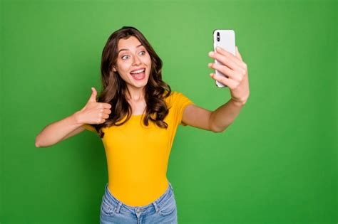 Premium Photo Portrait Of Girl Taking Selfie Showing Thumbup Isolated