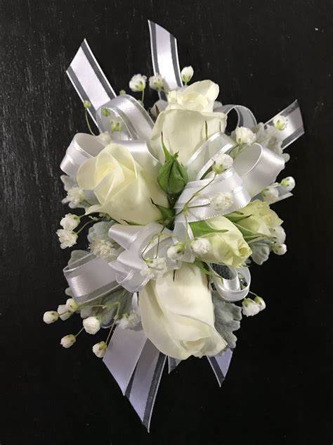 Ladies Wristband Corsage Featuring White Roses Dusty Miller And Babys