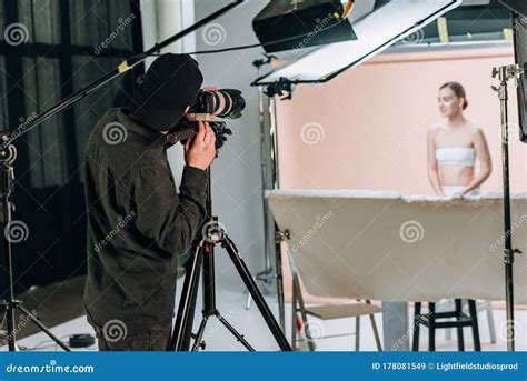 Selective Focus Of Videographer Filming Beautiful Female Model Stock
