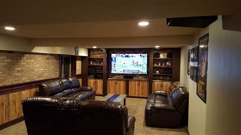 Basement Recroom View 75 Tv With Stacked Stone Backdrop The
