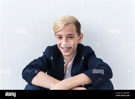 Close Up Of Teen Boy With Braces On Teeth Smiling On White Background