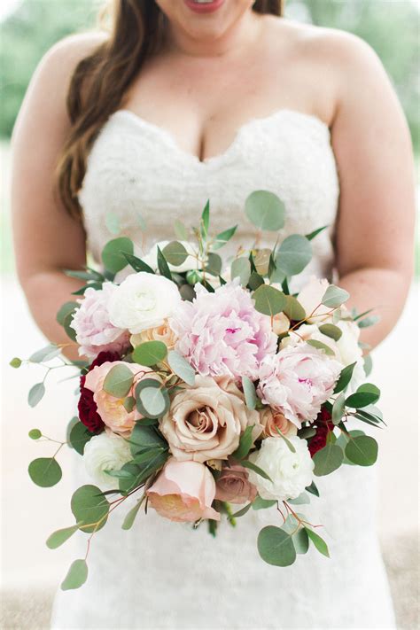 Looking for wedding flower ideas and inspiration? Bridal bouquet with peonies, antique rose, pops of ...
