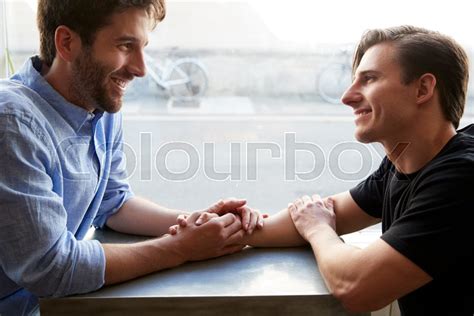 loving male gay couple sitting at table stock image colourbox